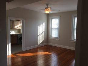 Washington apartment for rent - A room with a ceiling fan and two windows.