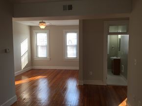 Washington apartment for rent - A room with wooden floors and a ceiling fan.