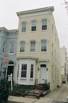 Washington apartment for rent - A white building with a black fence in front.