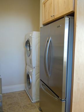 Washington apartment for rent - A stainless steel refrigerator and washing machine in a kitchen.
