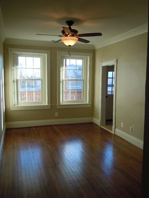 Washington apartment for rent - A room with a ceiling fan and two windows.