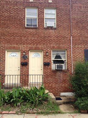 Washington apartment for rent - A red brick building with a white door and windows.