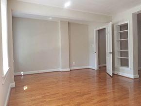Washington apartment for rent - A room with wooden floors and white walls.