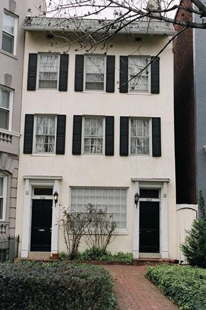 Washington apartment for rent - A white house with black shutters and a black door.