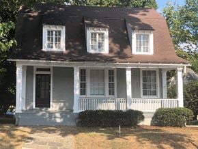 Washington apartment for rent - A white house with a black door and windows.