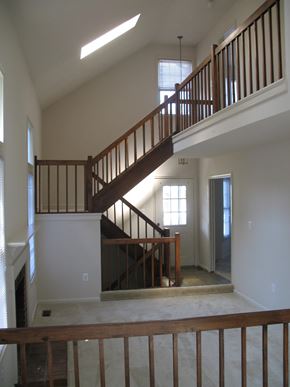 Vienna apartment for rent - A wooden staircase with a railing leads up to a second floor.