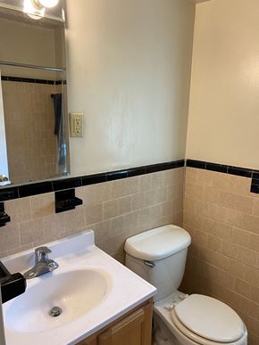 Washington apartment for rent - A white toilet sits next to a sink in a bathroom.