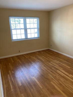 Washington apartment for rent - A room with a window and wooden flooring.