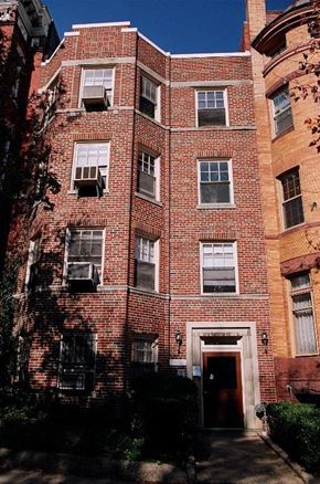 Washington apartment for rent - A red brick building with a black door and windows.