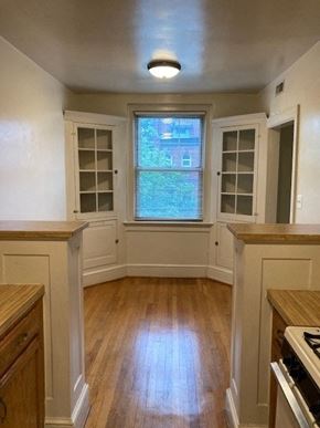 Washington apartment for rent - A kitchen with wooden floors and white walls.