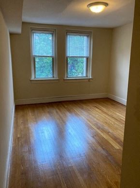 Washington apartment for rent - A room with wooden floors and two windows.