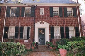 Washington apartment for rent - A red brick house with a black door and windows.