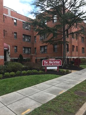 Washington apartment for rent - The MacArthur Apartments is a brick building with a red awning.