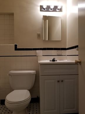Washington apartment for rent - A white toilet sits next to a white sink in a bathroom.