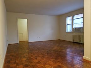 Washington apartment for rent - A room with a brown floor and a window.