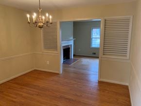 Mclean apartment for rent - A room with a chandelier and a fireplace.