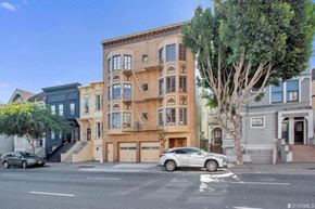 San Francisco apartment for rent - A street view of a residential area with a car parked on the side of the road.
