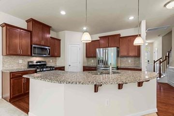 Morrisville house for rent - an open kitchen with a granite counter top and a sink