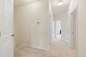 Morrisville house for rent - a bedroom and hallway with white walls and a closet