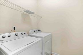 Morrisville house for rent - a white washer and dryer in a white laundry room with a white wall