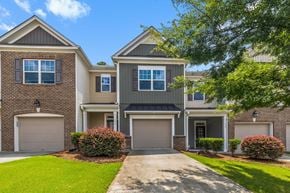 Morrisville house for rent - a house with two garage doors and a sidewalk in front of it