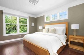 Grand Rapids house for rent - a bedroom with a bed and three windows