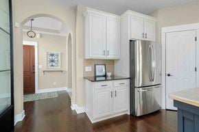 Grand Rapids house for rent - a kitchen with white cabinets and a stainless steel refrigerator