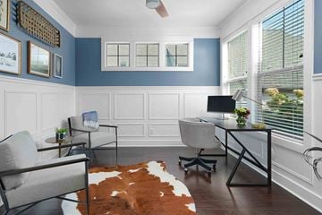 Grand Rapids house for rent - a living room with chairs and a desk with a computer