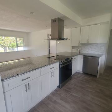 Lakeland apartment for rent - A kitchen with white cabinets and a granite countertop.