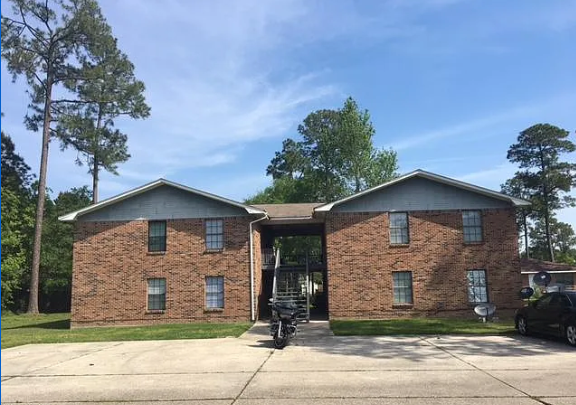Long Beach apartment for rent - A brick house with a garage door open.