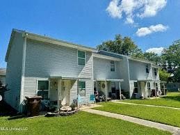 Long Beach apartment for rent - A white two-story house with a blue sky and clouds in the background.