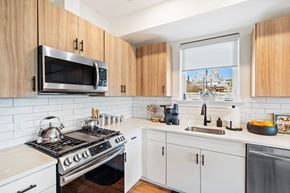 Newark apartment for rent - a kitchen with a stove and a sink and a window