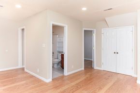 Clarksville house for rent - a living room with a hard wood floor and a door into a bathroom