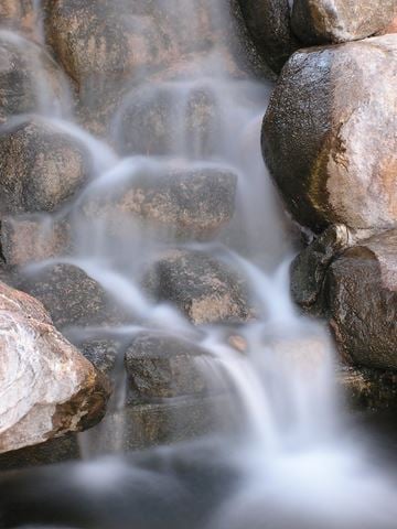 Yuma apartment for rent - A small waterfall cascades over a rocky surface.