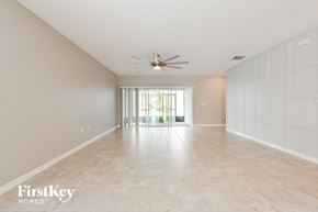 Groveland house for rent - a spacious living room with tile flooring and a ceiling fan