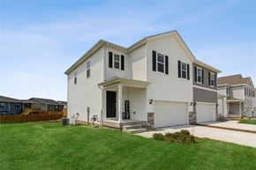 Waukee apartment for rent - A two-story house with a garage and a driveway.