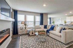 Waukee apartment for rent - A living room with a fireplace and a couch.