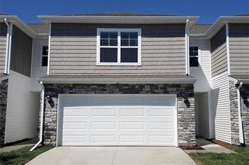 Waukee apartment for rent - A house with a garage door and a window.