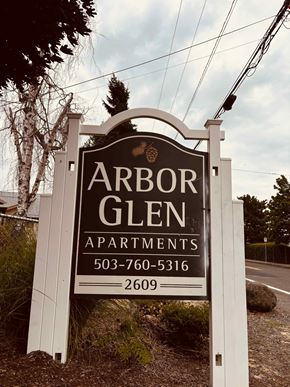 Portland apartment for rent - A sign for Arbor Glen Apartments with a phone number and area code.