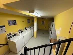 Portland apartment for rent - A hallway with yellow walls and white appliances.