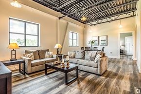 Columbus apartment for rent - A living room with a couch, coffee table, and two lamps.