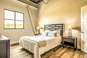 Columbus apartment for rent - A bedroom with a large bed and two lamps.