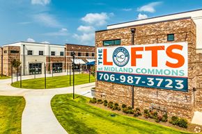 Columbus apartment for rent - A building with a sign that says "The Lofts at Midland Commons" and a phone number.