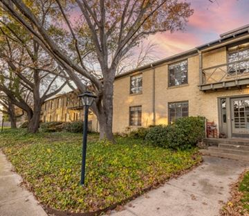 Dallas apartment for rent - the exterior of a house with trees and a sidewalk