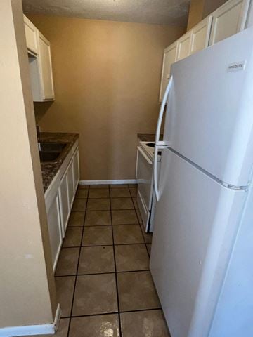 Long Beach apartment for rent - a kitchen with a refrigerator and a sink
