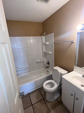 Long Beach apartment for rent - a bathroom with a toilet and a tub and a sink