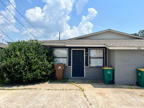 Long Beach apartment for rent - a house with a blue door and trash cans in front of it