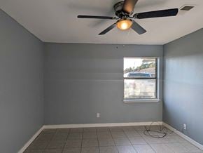 Long Beach apartment for rent - A room with a ceiling fan and a window.