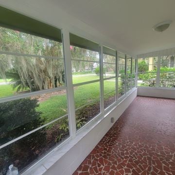 Lakeland apartment for rent - A room with a red floor and white walls has a row of windows.