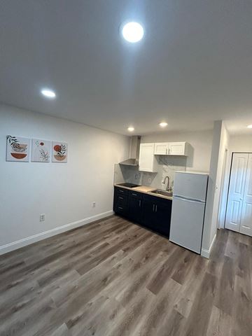 Lakeland apartment for rent - A kitchen with a refrigerator, cabinets, and a countertop.